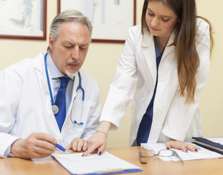 Doctors reviewing medical billing documents with RCM Experts